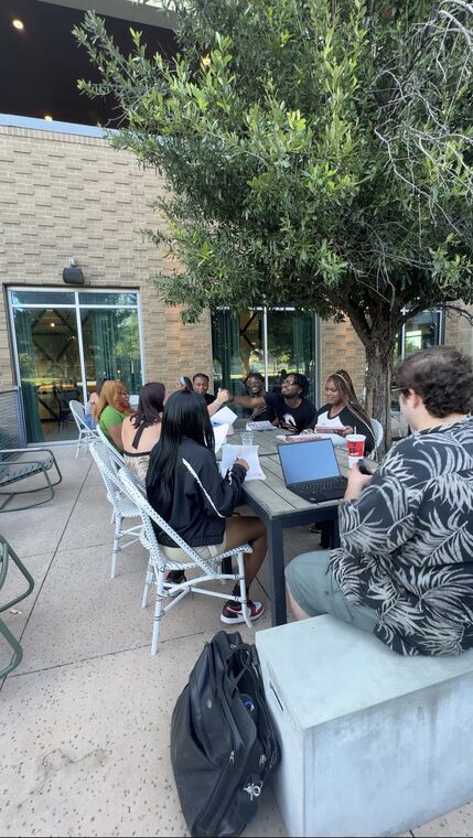 An outdoor patio Bible study on a summer evening
