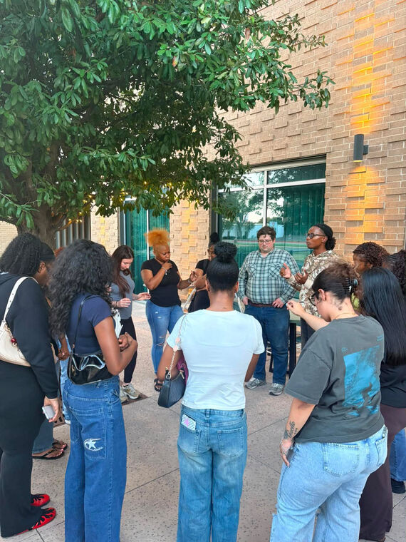 A prayer circle outside before study